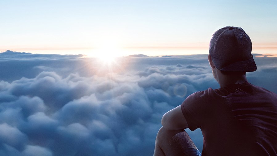 Man watching sun at horizon