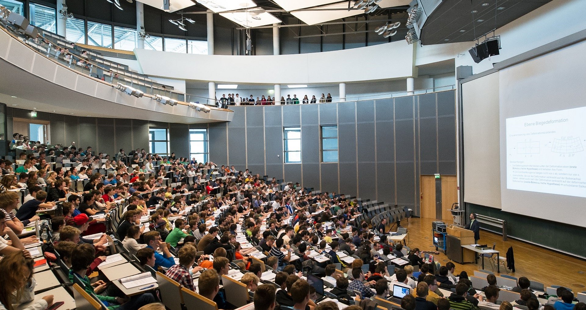 A full lecture hall during a presentation.