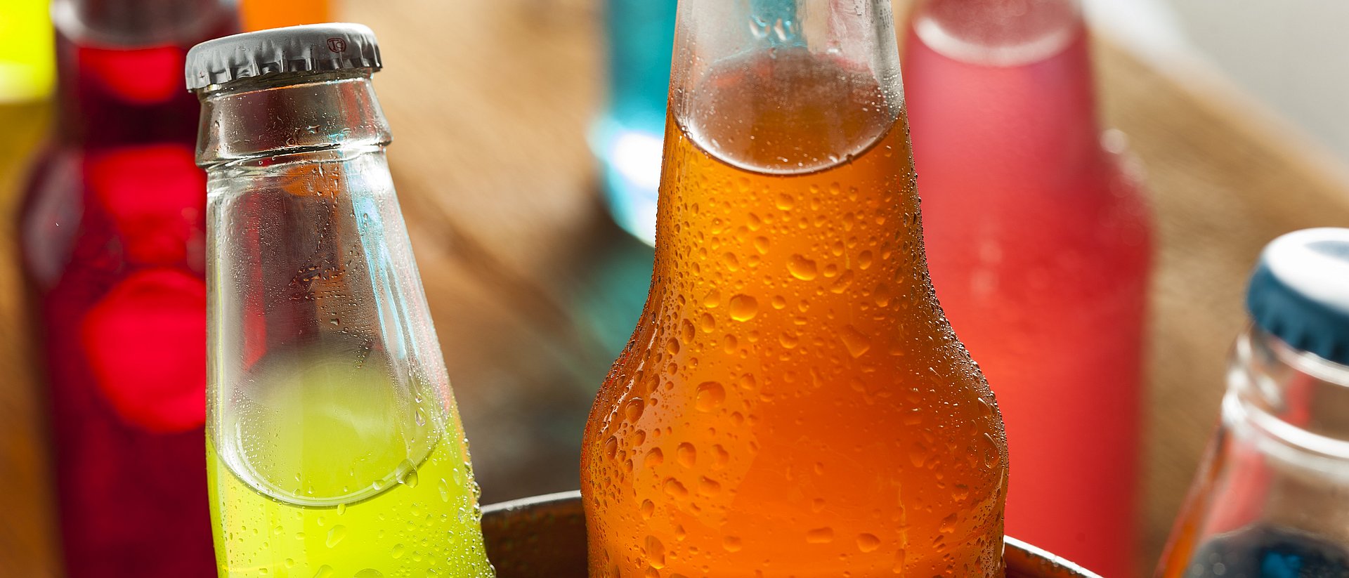 Bottles filled with colorful soft drinks.