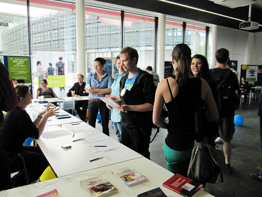 Multiple persons in the field of the information desk