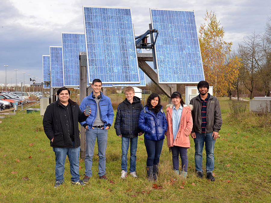 Jose Rivera (left) with his team (Viktor Vaklinov, Klaus Schreiber, Prerona Ray Baruah, Qunjie Zhou and Tanuj Ghinaiya, from left to right) in front of point No. 63084505 of the OpenGridMap, a solar collector near the TUM premises. (Photo: Andreas Battenberg)