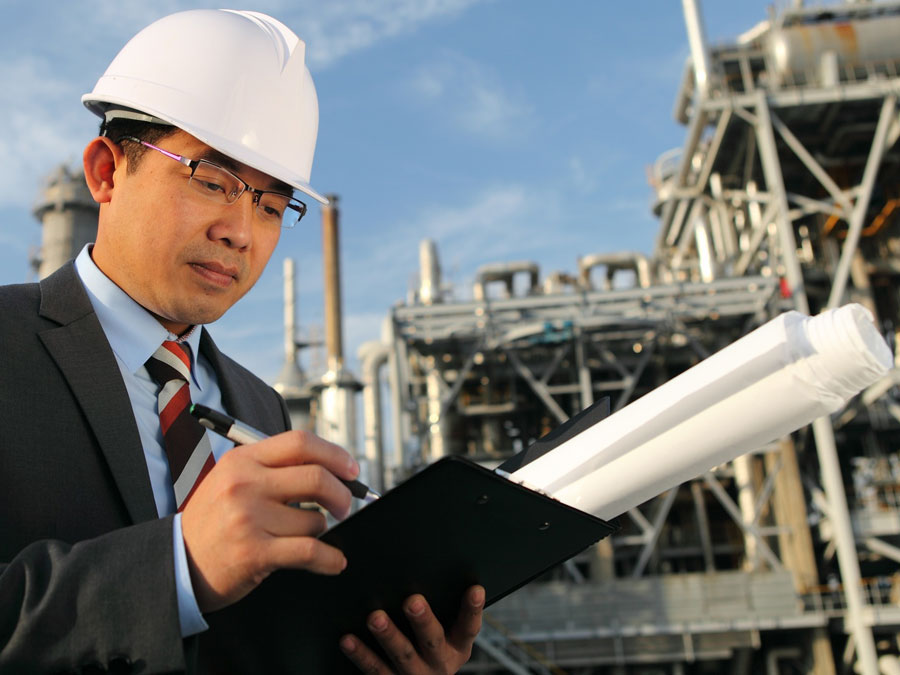 Entrepreneur standing in front of a factory.