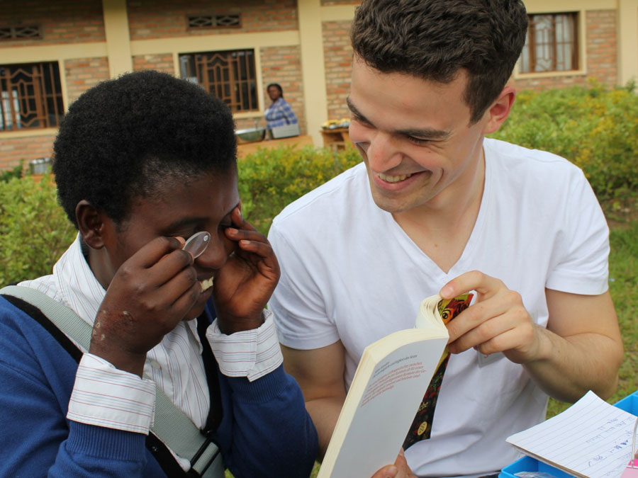 Jakob Schillinger helps with an eye test for new one-dollar glasses.