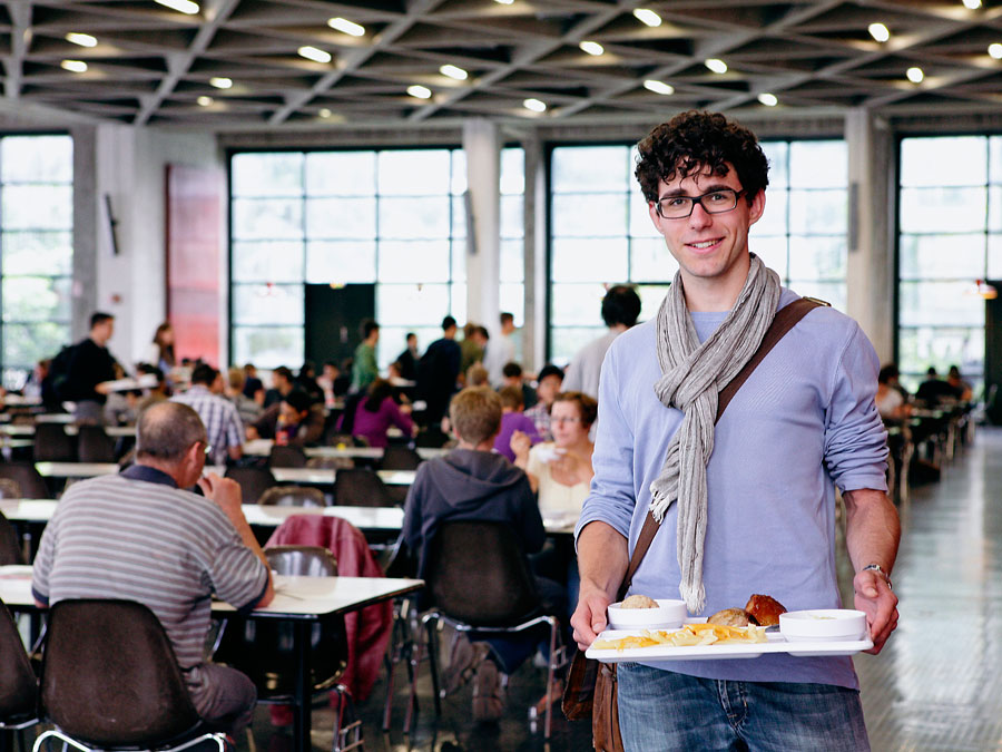 Student with a tray in canteen