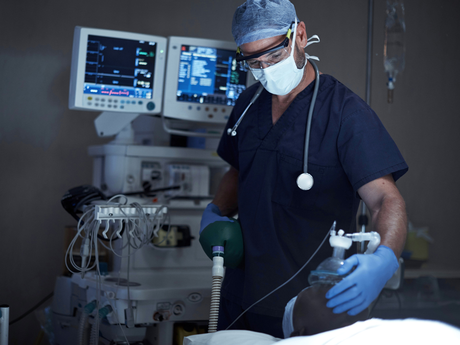 A man administering anesthesia.