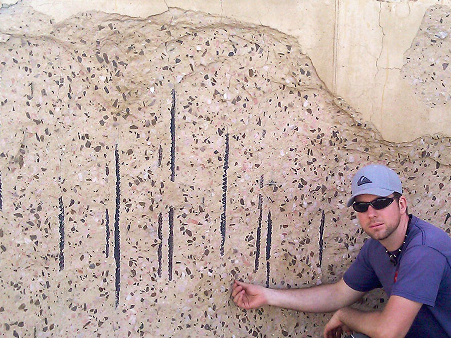 Ronald Richter sitting in front of a  concrete slab.