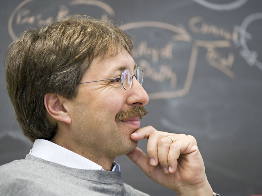 Professor Dirk Busch before a chalkboard.