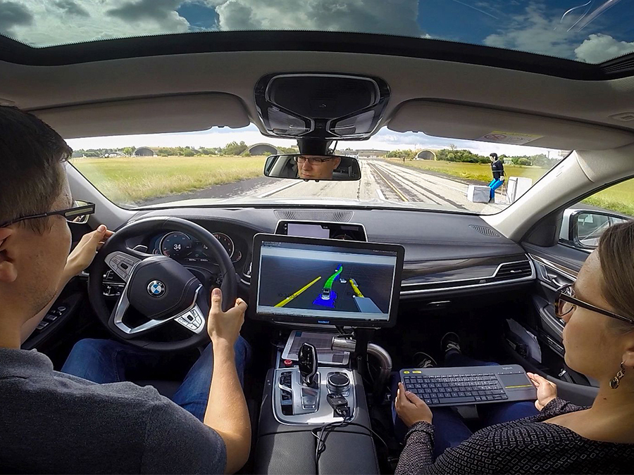 An autonomous vehicle avoiding a pedestrian dummy.