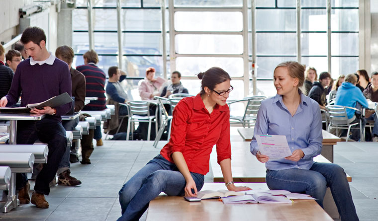 Two students learning together at the caféteria next to TUM's Audmax Two students learning together at the caféteria next to TUM's Audmax