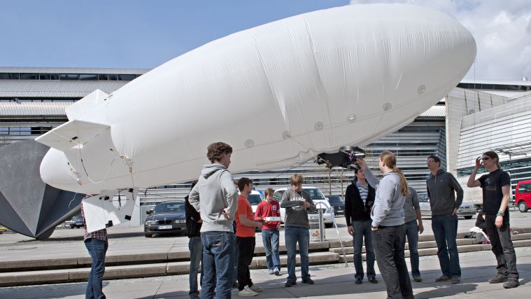 Students preparing the airship for launch. Students preparing the airship for launch.